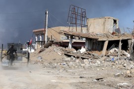 A destroyed building is seen near a government complex in the city of Ramadi