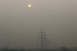 High tension electric pylons are pictured on a smoggy day in New Delhi