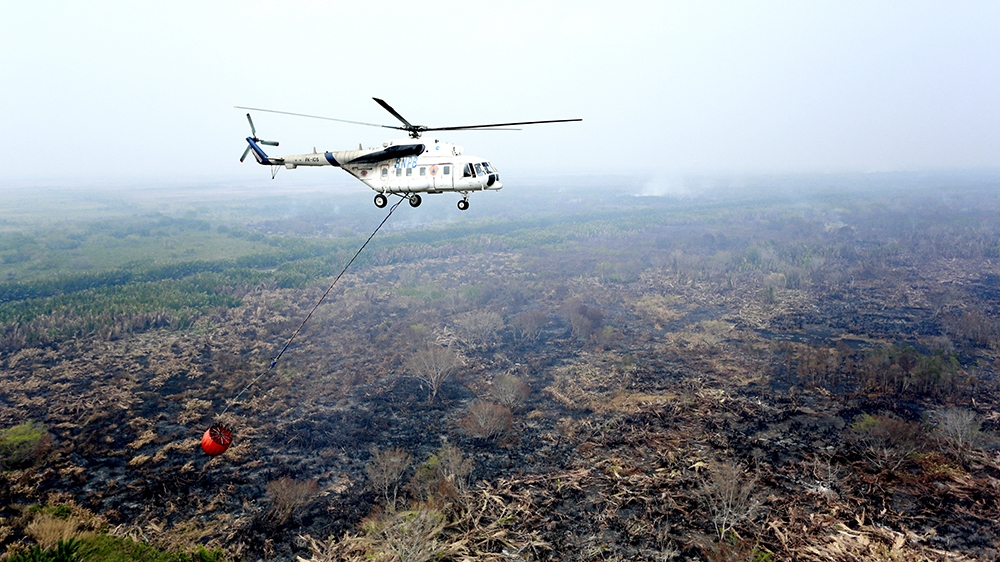 Water bombing helicopters in South Sumatra are now only able to see the full extent of the devastation [Al Jazeera]