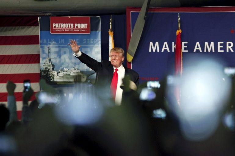 U.S. Republican presidential candidate Donald Trump waves to the crowd at a Pearl Harbor Day rally aboard the USS Yorktown Memorial in Mount Pleasant
