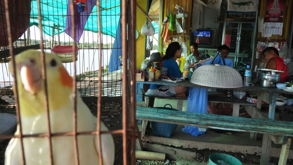 The local village shop acts as a meeting area for Ban Khun Samut Chin village community [Jack Picone/Al Jazeera]