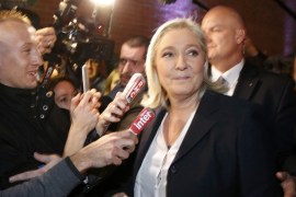 French National Front political party leader and candidate Marine Le Pen is surrounded by media [REUTERS]