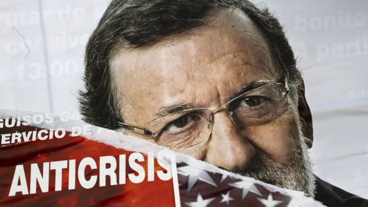 A torn campaign poster of Spanish PM Mariano Rajoy