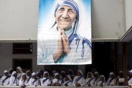 File photo of Catholic nuns from the order of the Missionaries of Charity gather under a picture of Mother Teresa in Kolkata