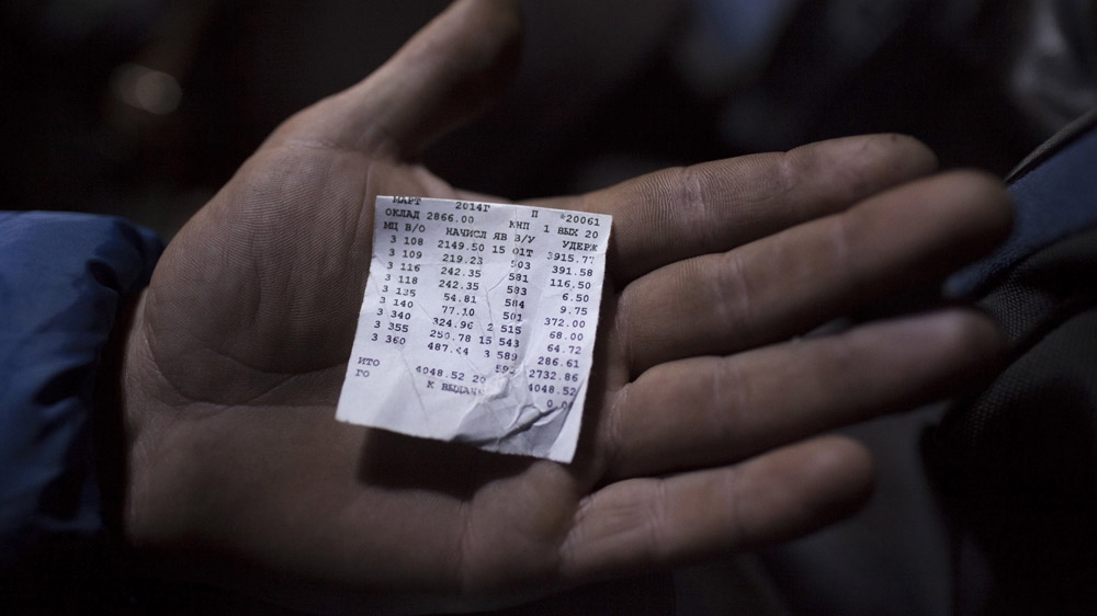 A miner in Krasnodon shows his last monthly paycheque. It amounts to little more than 4,000 grivnas or $260. The cost of feeding a family can reach 5,000 grivnas or $330, and living costs keep rising, particularly since the events at Maidan have thrown the country into turmoil. [Janos Chiala and Tali Mayer/Al Jazeera]  