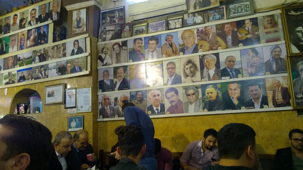 The teahouse's walls have photos of dozens of local and foreign politicians [Osama Bin Javaid/Al Jazeera]