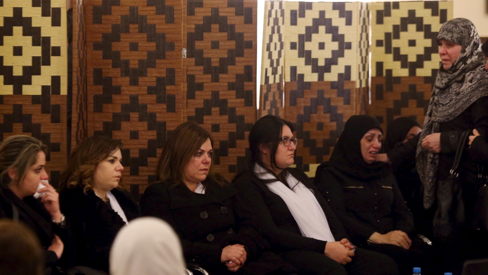 Relatives of Kantar mourn his death as they accept condolences on Sunday [Hasan Shaaban/Reuters]