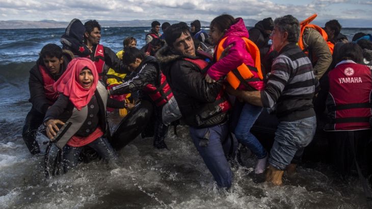 Afghan migrants disembark safely from their frail boat in bad weather on the Greek island