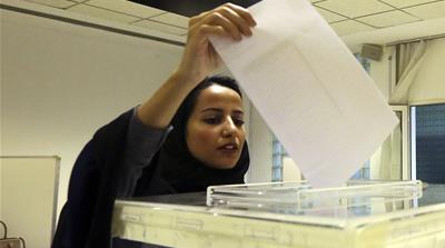 A Saudi woman casts her ballot at a polling centre in Riyadh, Saudi Arabia [AP]