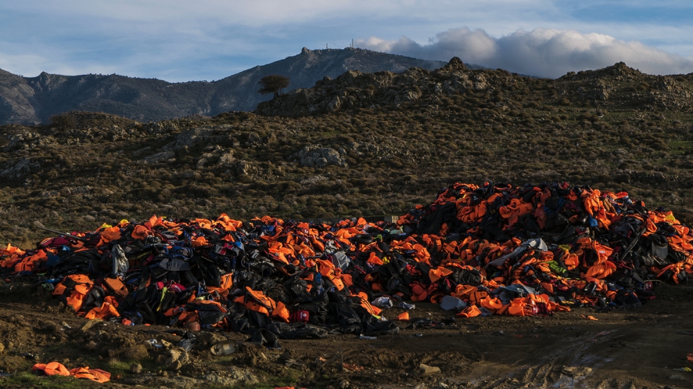Many mounds of life jackets cannot be reached by vehicle because of the rough terrain on Lesbos [Sorin Furcoi/Al Jazeera]