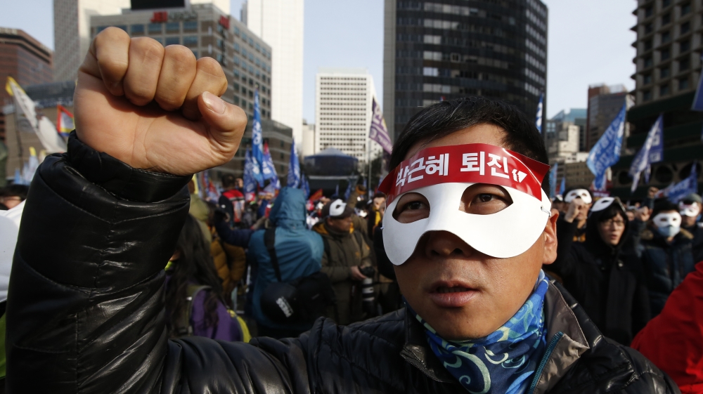 Demonstrators carried signs and banners with slogans that included 'Park Geun-hye step down' [Lee Jin-man/AP]
