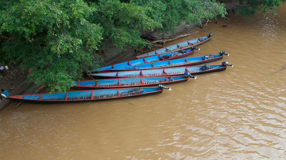 Canoes wait at the Ecuador-Colombia border [Priyanka Gupta/Al Jazeera]