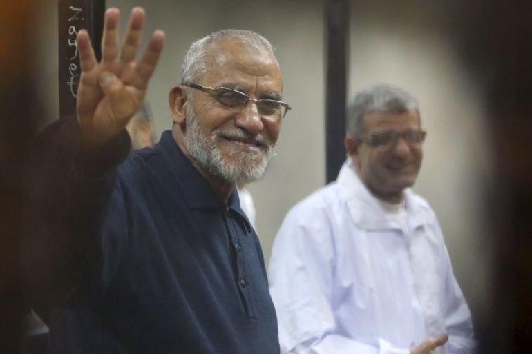 File photo of Muslim Brotherhood''s Supreme Guide Mohamed Badie flashing the Rabaa sign at a court on the outskirts of Cairo