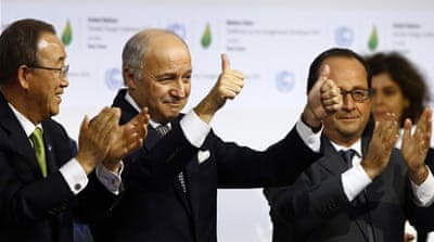 French foreign minister and president of the COP21 Laurent Fabius applauds while UN Secretary General Ban Ki-moon and French President Francois Hollande applaud after the final conference of the COP21 [AP]