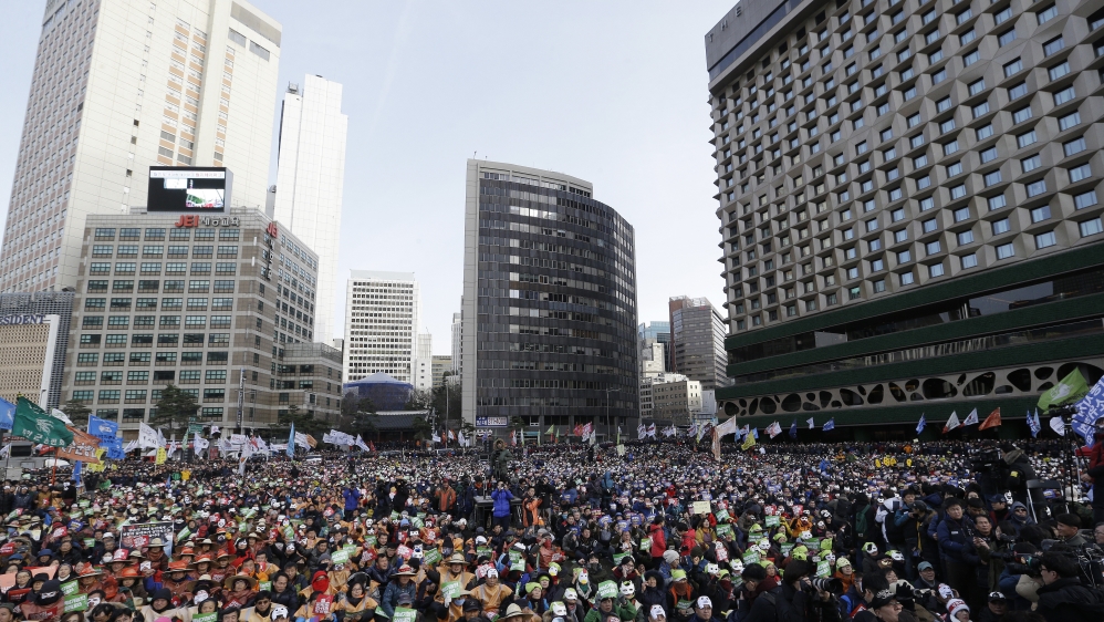 An estimated crowd of 30,000 people marched through the city centre in Seoul on Saturday [Ahn Young-joon/AP]
