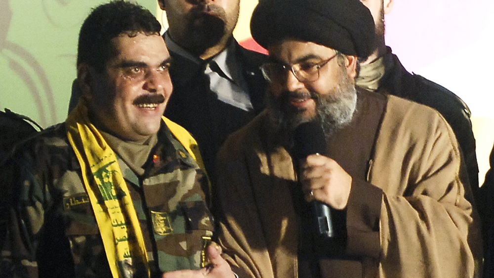 Hezbollah leader Hassan Nasrallah (R) welcomed Kantar after his release from Israel at a massive rally in south Beirut in July 2008 [AP]