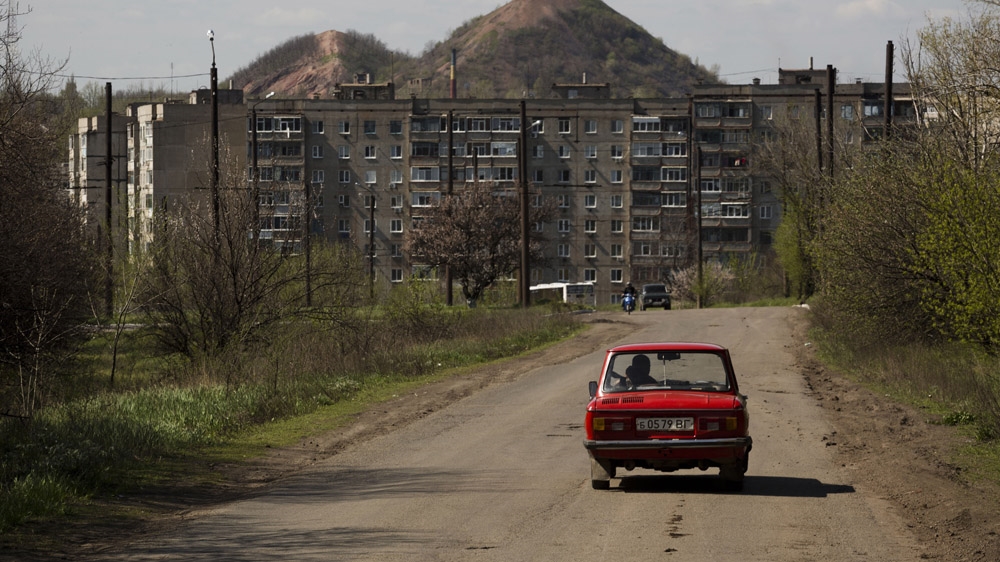 Krasnodon is a mining town some 5km from the Russian border. In the background is the defining feature of the Donbass landscape: the terrikon, a mound of debris excavated by a mine. [Janos Chiala and Tali Mayer/Al Jazeera]  