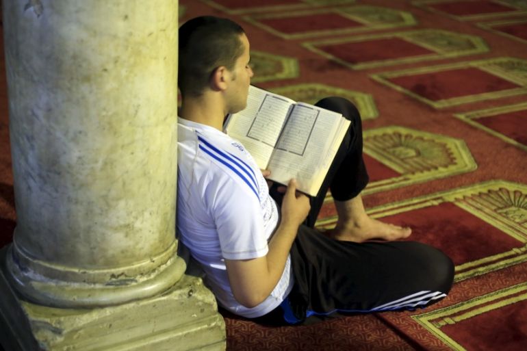 Man reads the Koran after breaking his fast during the holy month of Ramadan at Al-Azhar Mosque in the old Islamic area of Cairo, Egypt