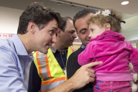Prime Minister Justin Trudeau greets refugees fleeing the Syria, during their arrival at Pearson International airport, in Toronto [AP]