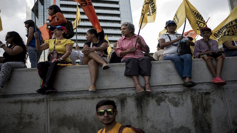 Opposition supporters wait for the closing rally of its campaign to begin in Caracas [Alejandro Cegarra/Al Jazeera]