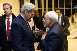 US Secretary of State John Kerry talks with Iranian Foreign Minister Mohammad Javad Zarif, right, after the IAEA verified that Iran has met all conditions under the nuclear deal, in Vienna [AP]