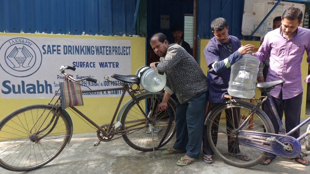 People are collecting Sulabh Water from the Madhusudankati plant. Sulabh water is fast becoming popular among the villagers and Sulabh authorities are planning to increase the capacity of the plant [Shaikh Azizur Rahman/Al Jazeera]