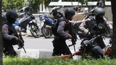 Police officers take their position near the site where an explosion went off in Jakarta, Indonesia [AP]