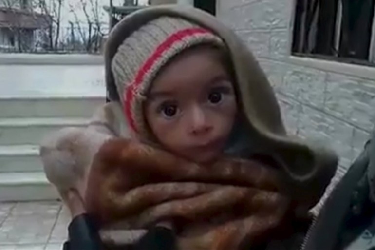 A toddler is held up to the camera in this still image taken from video said to be shot in Madaya