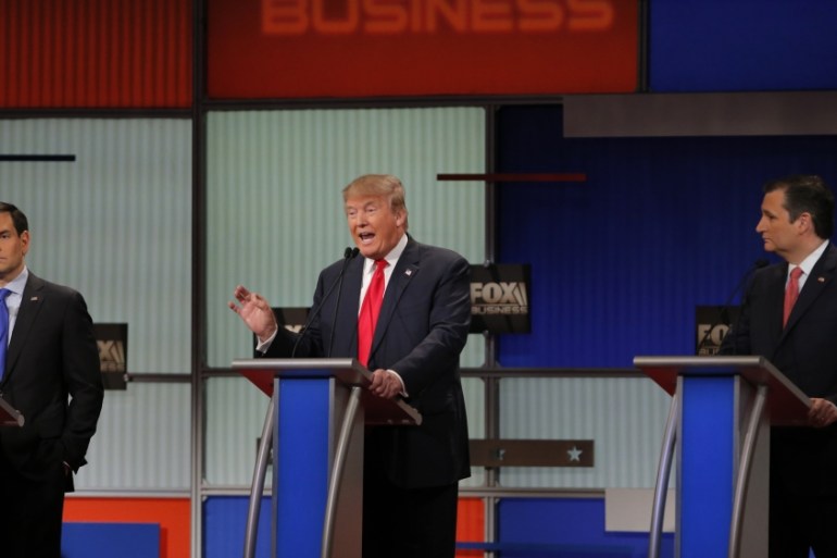 Republican US presidential candidate businessman Donald Trump speaks as rival candidates Senator Marco Rubio and Senator Ted Cruz look on [REUTERS]