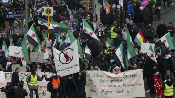 A group of protesters with Syrian flags rally during a demonstration of German farmers and consumer rights activists against mass animal husbandry and genetic engineering in Berlin