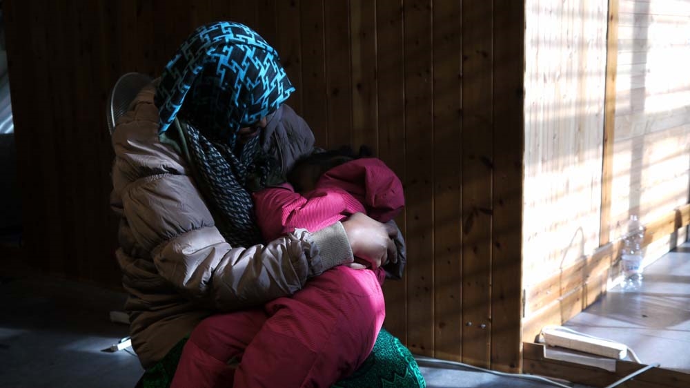 Leila holds her daughter Aisha [Sean O'Neill/Al Jazeera]