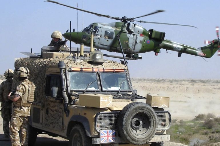 File photo of a Royal Marines helicopter preparing to land as British forces in a Snatch Land Rover set up a checkpoint south of Basra