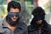 Afghan security officers escort two alleged ISIL members in Nangarhar province, Afghanistan [EPA]