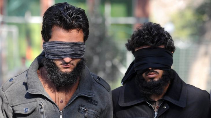 Afghan security officers escort two of six alleged members of the group calling themselves ISIL, arrested after clashes with Afghan security forces in Nangarhar province, Afghanistan [EPA]