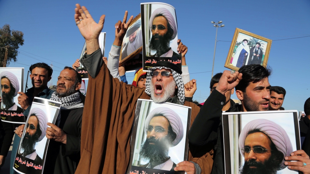 Shia protesters hold posters showing Nimr as they chant slogans against the Saudi government in Najaf, south of Baghdad, onMonday [Karim Kadim/AP Photo]