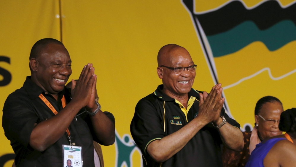 File photo of South Africa's President Jacob Zuma celebrating his re-election as party President alongside his deputy Cyril Ramaphosa at the National Conference of the ruling African National Congress