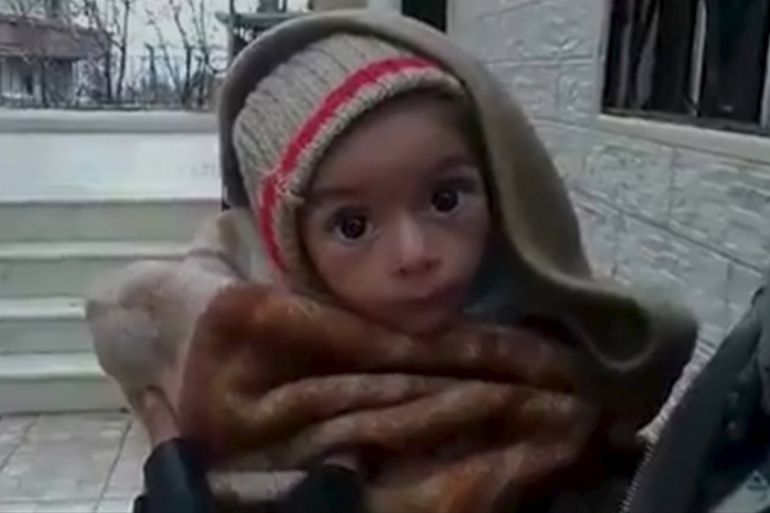 A toddler is held up to the camera in this still image taken from video said to be shot in Madaya on January 5 [REUTERS]