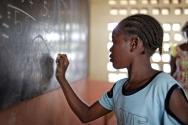 A girl working out sums at the blackboard during a math lesson at the refugee camp ''St Sauveur'' in Bangui, Central African Republic [Getty]
