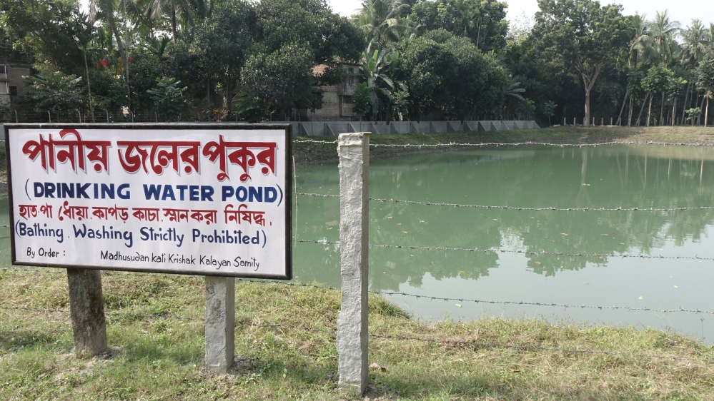 Water from this pond is used to feed the Sulabh Water plant at Madhusudankati village. 'Bathing and washing of clothing are not allowed in this pond,' warns a signboard by the pond [Shaikh Azizur Rahman/Al Jazeera]