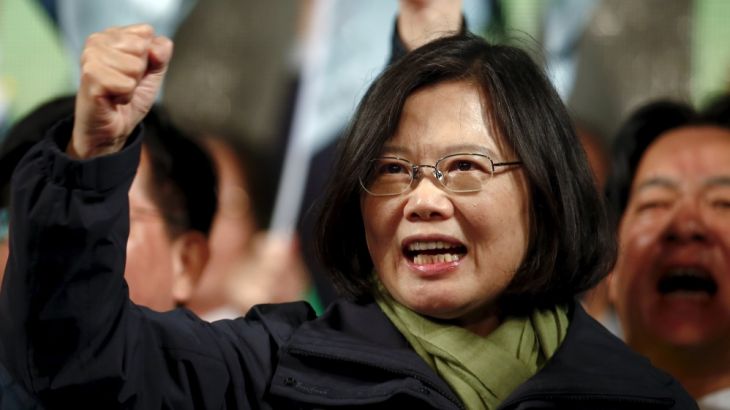 Democratic Progressive Party (DPP) Chairperson and presidential candidate Tsai Ing-wen shouts slogans as she greets supporters after her election victory at party headquarters in Taipei