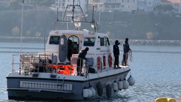 A coast guard vessel arrives with the dead bodies of migrants at the port of Vathi
