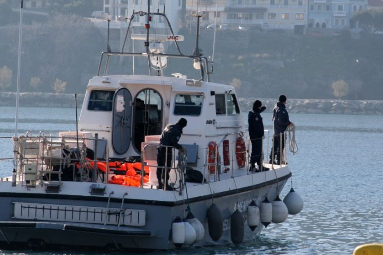 A coast guard vessel arrives with the dead bodies of migrants at the port of Vathi