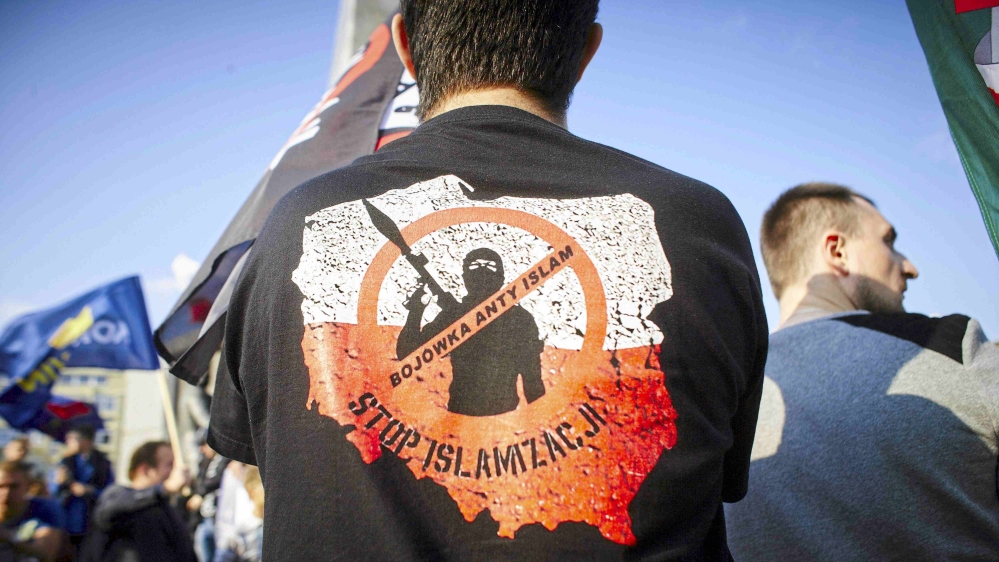European far-right parties have called refugees streaming into the region a 'ticking timebomb', a Muslim 'invasion' that will bankrupt nations and undermine the continent's Christian roots. The words on the T-shirt read: 'Anti-Islam militia. Stop Islamization' [Marcin Stepien/Reuters]