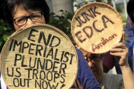 Activists hold out rattan woven baskets with messages denouncing the Enhanced Defense Cooperation Agreement(EDCA) during a protest outside the Supreme Court in Manila