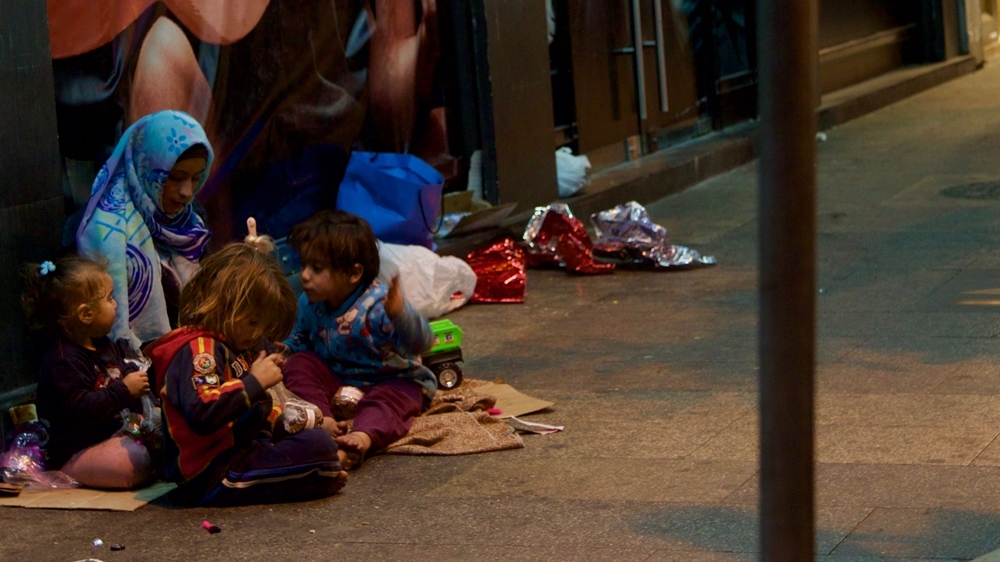 Sana begs with her children on the streets of Beirut [Priyanka Gupta/Al Jazeera]