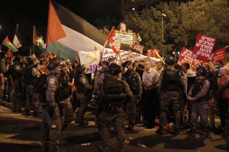 Arab-Israelis and Israeli left wing activists protest against the Israeli offensive on Gaza, in Haifa