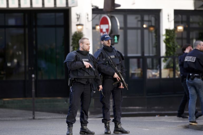 French police secure the area after a man was shot dead at a police station in the 18th district in Paris