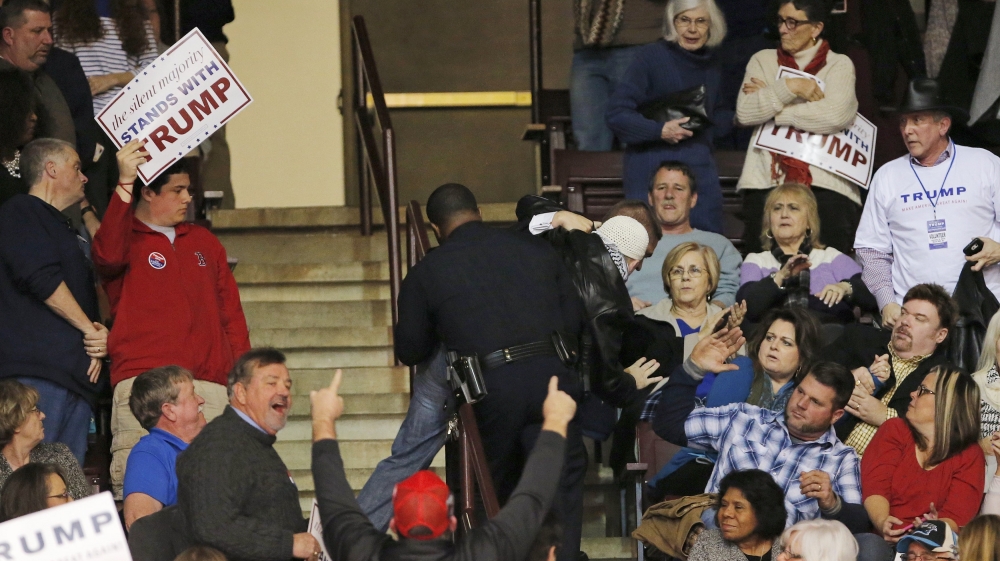 Security personnel removed several protesters from Trump's campaign rally during his speech [Reuters]