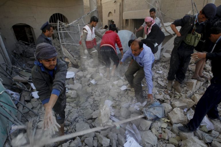 Policemen and medics remove debris as they search for victims at the site of a Saudi-led air strike on the police headquarters in Yemen''s capital Sanaa
