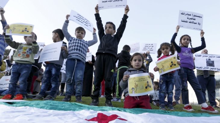 Syrian children carry placards as they call for the lifting of the siege off Madaya and Zabadani towns in Syria, in front of the offices of the U.N. headquarters in Beirut, Lebanon